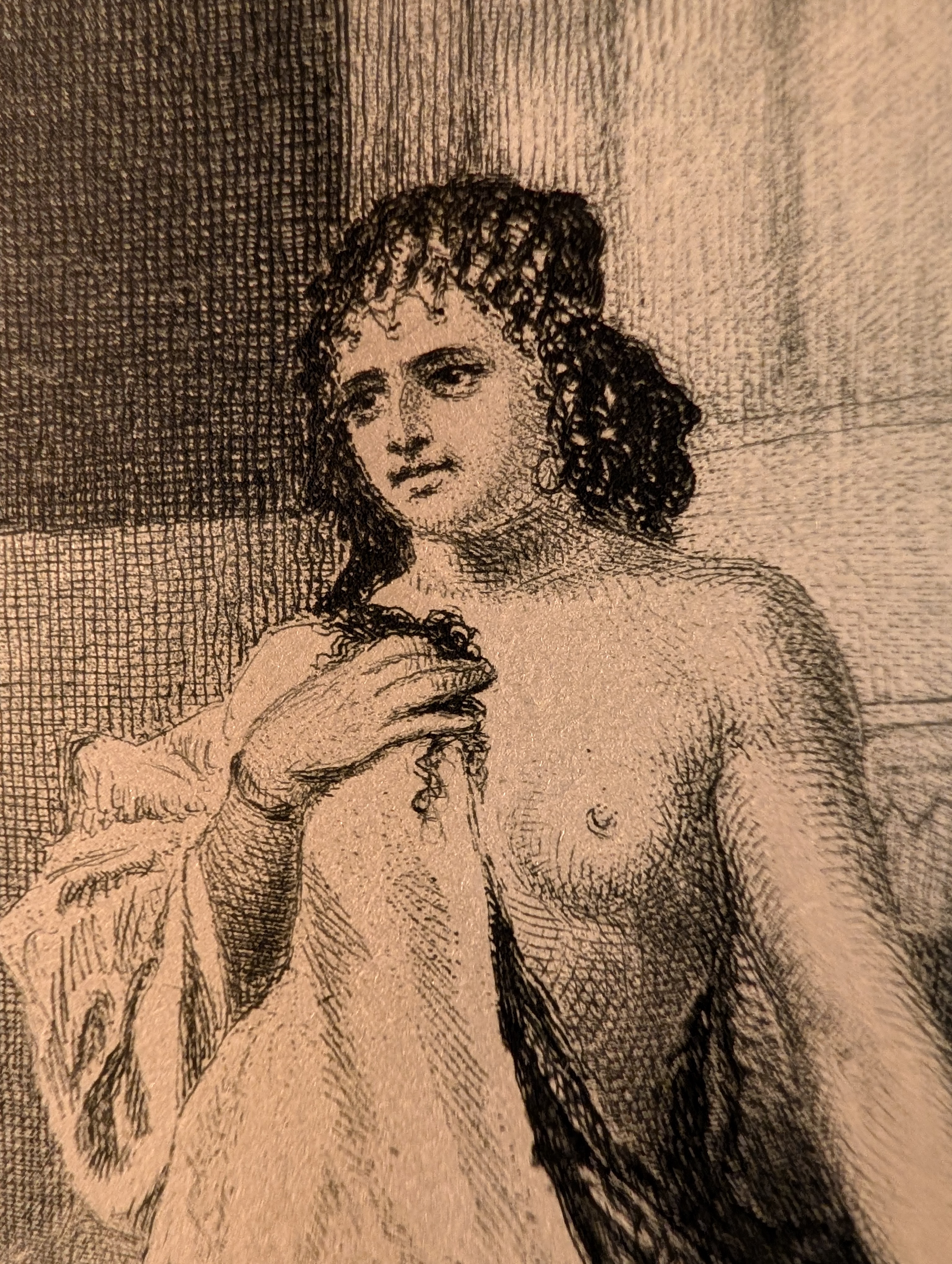 Engraving of a semi-draped woman with curly dark hair